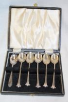 Five silver teaspoons with scroll handles in velvet lined case and one other non-matching silver