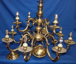 A good quality brass twelve-branch ceiling chandelier with scroll supports (slight damage),