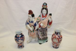 A Japanese Imari pottery figure of two musicians,
