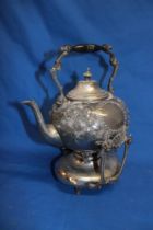 A Victorian electro-plated spirit kettle with raised floral decoration on shaped stand with burner