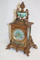 A French brass mantel clock with porcelain circular dial and porcelain scenic side panels 12 1/2"