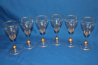 A set of six good quality glass wine goblets with gilt over-laid leaf decoration,