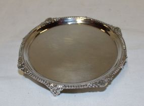 A small George V silver waiter tray with decorated edge, 4½" diameter, London marks 1926 by Paige,