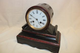 A Victorian mantel clock with circular enamel dial in black slate and red marble domed case (af)