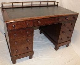 A Victorian oak rectangular twin pedestal desk with inset leather writing surface,