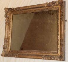 An old rectangular wall mirror in ornate gilt frame,