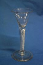 A George III cordial glass with air twist stem and circular base,