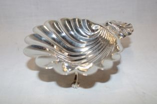 A good quality silver scallop-shaped sweetmeat dish on scroll-shaped legs,