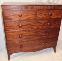 A mid-19th century mahogany chest of two short and three long drawers with turned handles on
