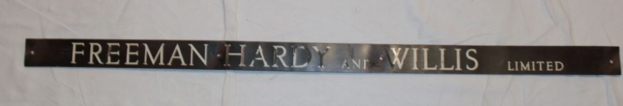 An old bronze rectangular name plaque "Freeman Hardy & Willis Ltd" 2" x 36"