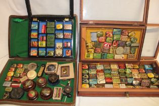 A collection of over 120 various gramophone needle tins contained in three display cases including