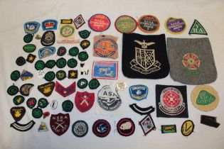 A selection of various cloth badges including Girl Guides, Swimming, National Rifle Association etc.