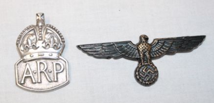 A silver ARP lapel badge and a copy German cap eagle
