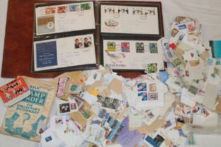 An album containing a selection of GB First Day covers,