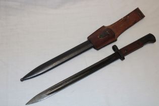 A Second War Czech bayonet with blackened steel single edged blade in steel scabbard with leather