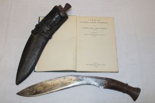 A Second War Gurkha kukri with 10" curved blade and polished wood hilt in leather sheath together
