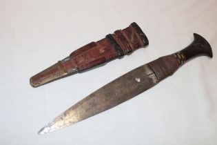 A small African dagger with 7½" double-edged blade in leather sheath