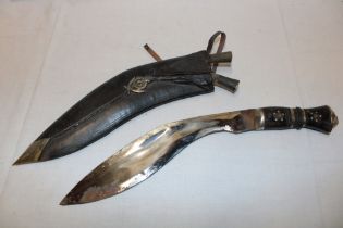 A Ghurka kukri knife in leather scabbard bearing a 5th Ghurka rifles badge