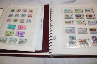 Two boxed albums containing a collection of Jersey stamps, mainly mint including blocks,