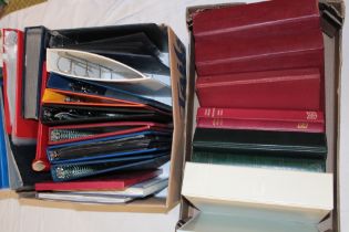 Two boxes containing a large selection of empty stamp folder albums and stock books