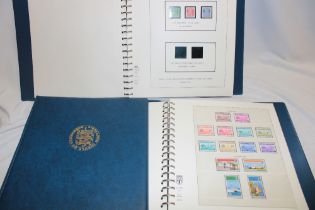 Two boxed albums containing a collection of Guernsey mint and used stamps,