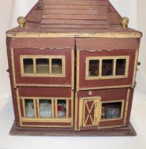 A 1930's wooden constructed dolls house with double opening front revealing a selection of period