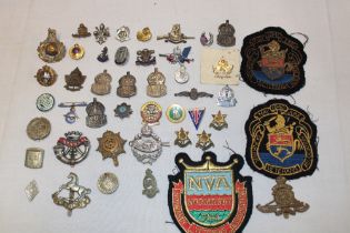 A selection of various military badges and insignia together with sweetheart's brooches - Middlesex
