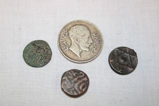 A Middle Eastern silver coin and three other bronze coins