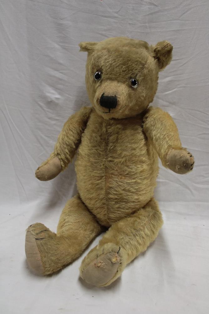 An old plush covered straw and flock filled teddy bear,