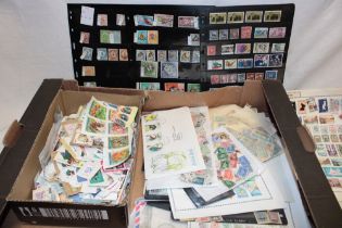 A box containing various packets of mixed world stamps,