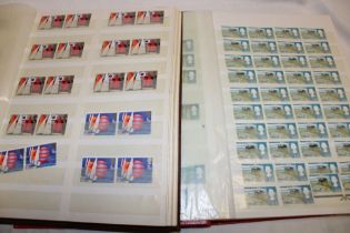 Two stock books containing a collection of EIIR GB mint stamps including pairs, blocks etc.