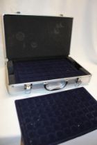 An aluminium coin collectors case with internal fitted trays