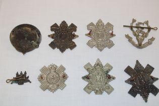 Seven various Scottish Highland cap badges and insignia including Seaforth Highlanders Territorial