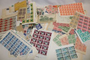 A box containing various British Commonwealth and World stamps including mint part sheets,