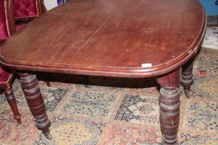 A Victorian mahogany rectangular extending dining table on turned tapered legs,