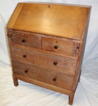 A 1930's/40's limed oak bureau by Heal & Son Limited London with pigeon holes and drawers enclosed