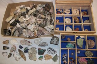 A display case and box containing a collection of mineral specimens including an unusual feldspar