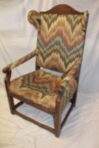 A large 19th century oak open arm wing easy chair upholstered in fabric on square-shaped legs