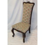 A Victorian mahogany prayer-style chair upholstered in floral tapestry on scroll-shaped legs