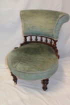A Victorian mahogany easy chair with upholstered seat and back on turned legs with castors