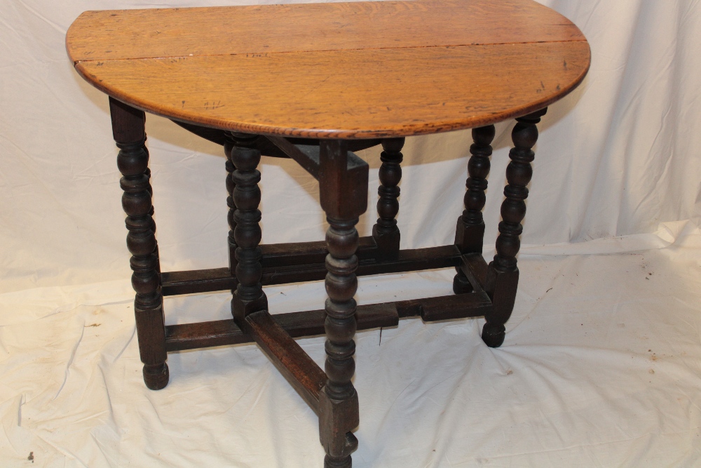 A Charles II and later oak oval gate-leg dining table on bobbin turned supports, - Image 2 of 3