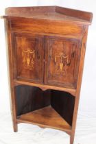 A 19th century inlaid rosewood corner cabinet with cupboard enclosed by two decorated panelled