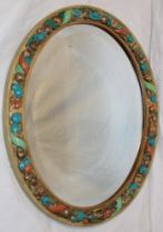 A good quality bevelled oval wall mirror in fruit decorated painted frame,