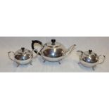 A good quality silver-plated three-piece tea set comprising circular tea pot with ebonised handle,