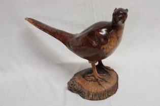 A rustic carved figured wood model of a cock pheasant,