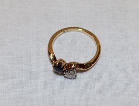 An 18ct gold dress ring set a diamond and sapphire (2.