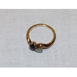 An 18ct gold dress ring set a diamond and sapphire (2.