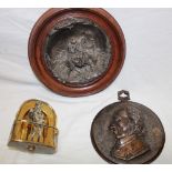 A silver plated circular relief decorated plaque depicting Mary, Joseph and Jesus,