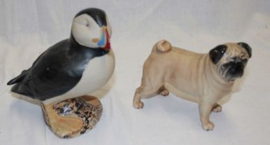 A Beswick china figure of a pug and an Isles of Scilly pottery figure of a puffin by John Bordeaux