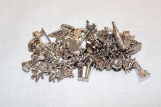 A silver charm bracelet mounted with numerous silver charms
